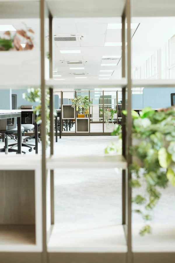 View through decorative shelving of study spaces.