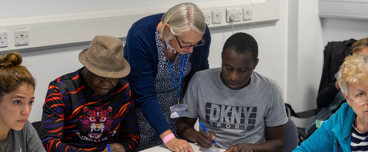 An EAP tutor interacting with a group of students