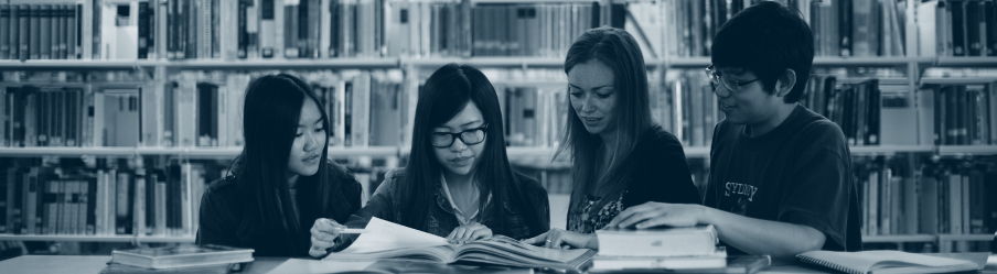 Image of four students studying together in the library